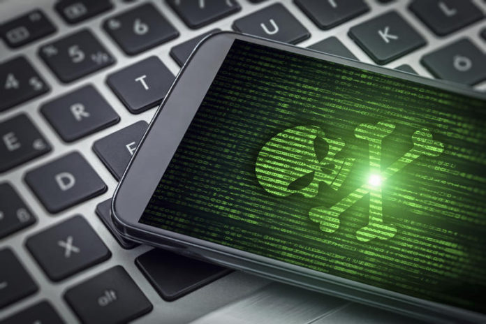skull of death on smartphone screen Троянец за Android използва смартфоните, за да атакува безжичните маршрутизатори